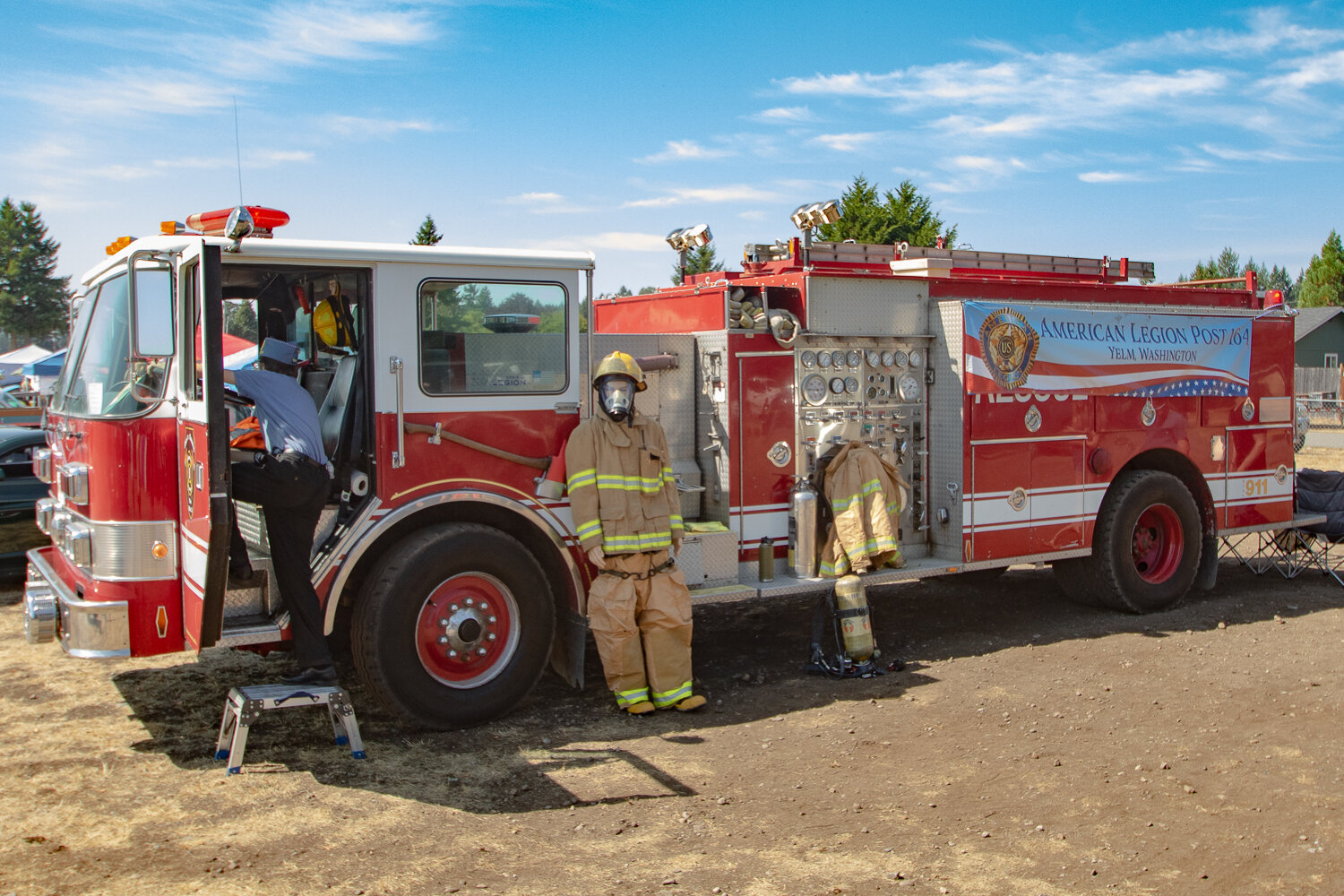 A car show attendee gets into the cab of George Gendron of Roy’s 1990 Pierce fire truck on Saturday, Sept. 2, at the 16th annual Military Heroes Car Show in Rainier at Wilkowski Park.