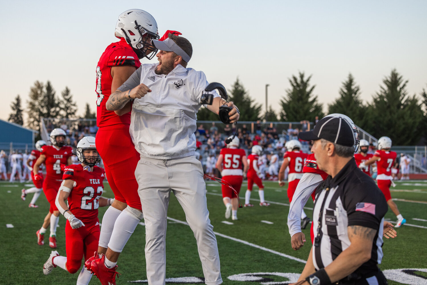 A Yelm player celebrates with a Tornado football coach at their Sept. 8 game against Union. The Tornados will take on Central Kitsap, Friday, Sept. 15.