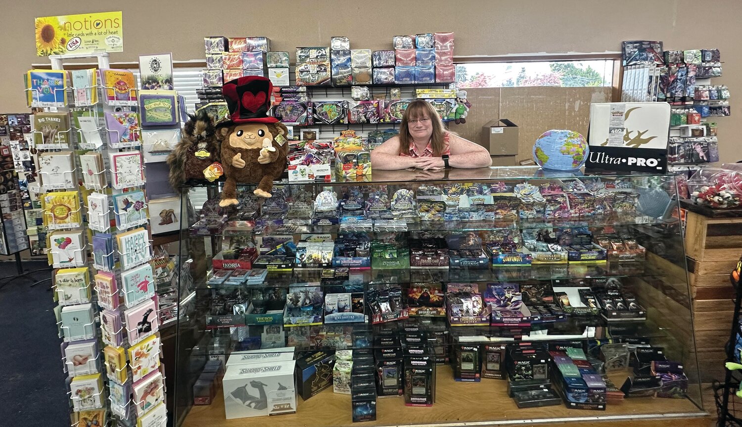 Funtime Toys & Gifts owner Heather Ekland poses behind the counter at the store’s new location at 303 First St.