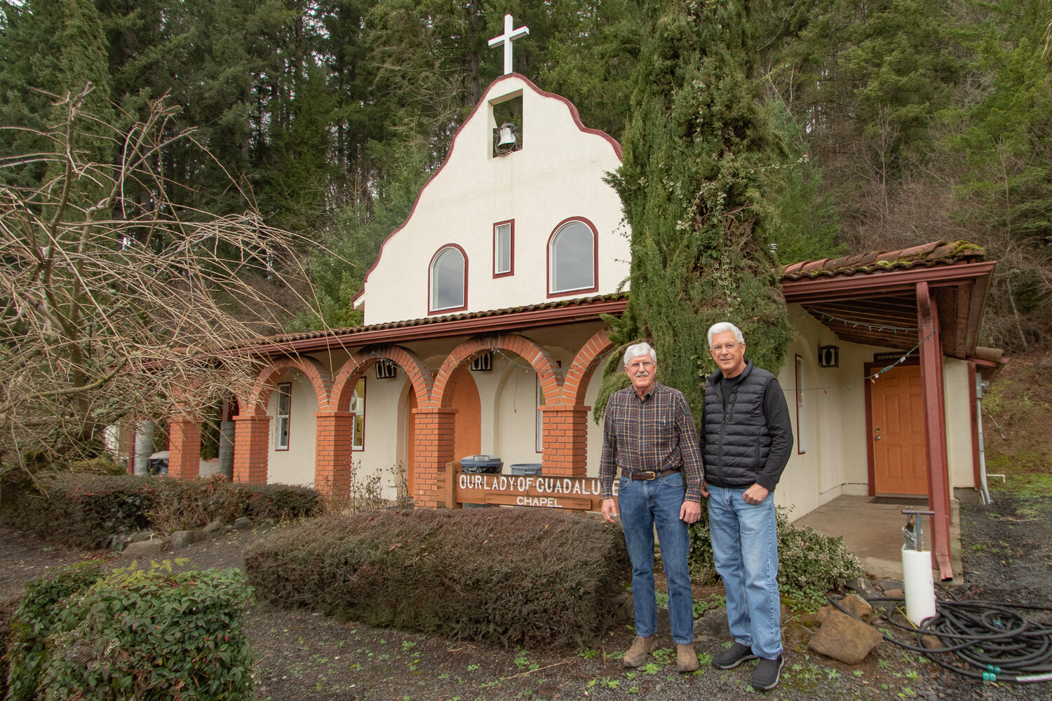 Owen Sexton for the Nisqually Valley News
Brothers Jack, left, and Bob DeGoede, stand, on Tuesday, Jan. 30, in front of the Our Lady of Guadalupe Chapel, which was built by their father, Hank. The chapel sits less than a mile from the DeGoede Bulb Farm in Mossyrock, which Jack and Bob just sold after retiring last summer. Below, a photo of Hank DeGoede, founder of DeGoede Bulb Farm in Mossyrock, hangs on a wall in his sons’ office at the Our Lady of Guadalupe Chapel.